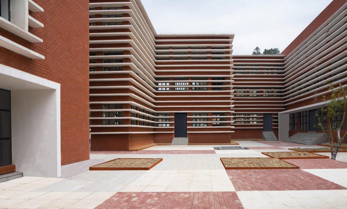 The courtyard is defined by repeated horizontal facade elements.
