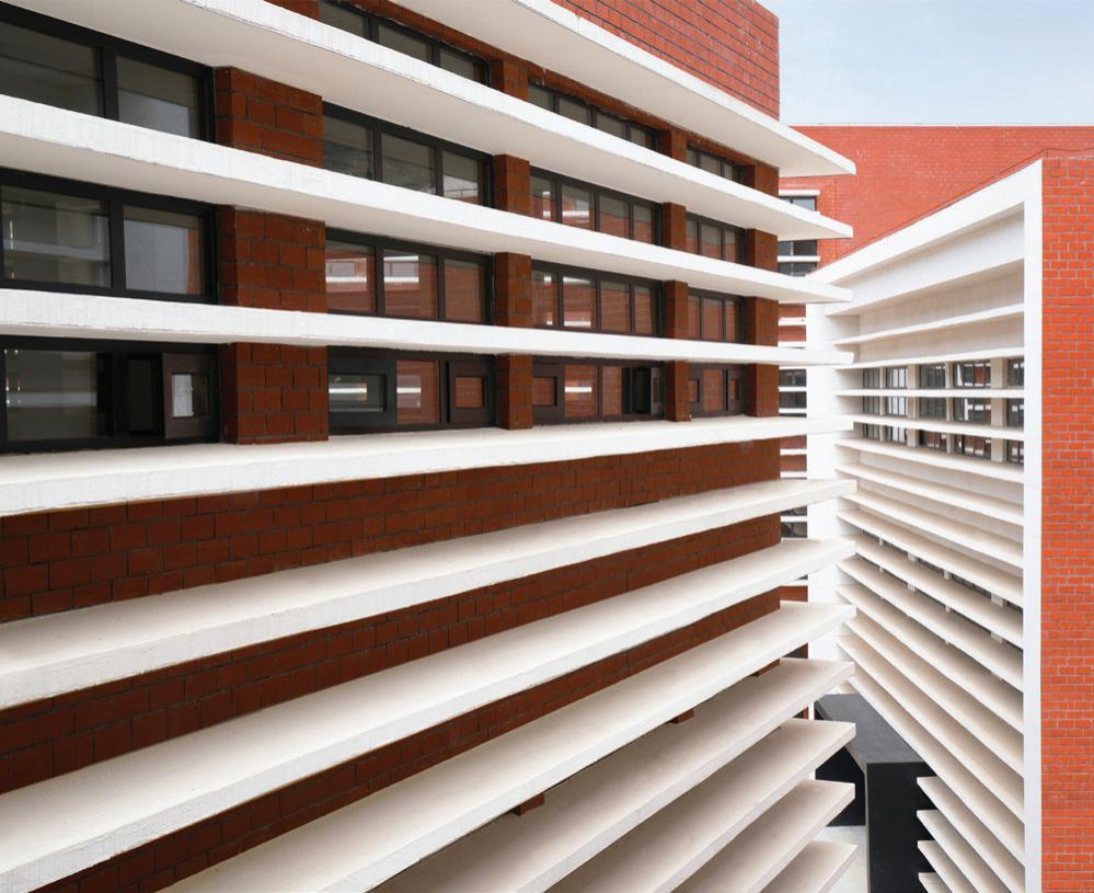 Horizontal white bands against red brick.